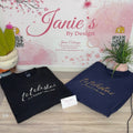 Two sweatshirts with 'telestial' text on a wooden surface with a decorative background.