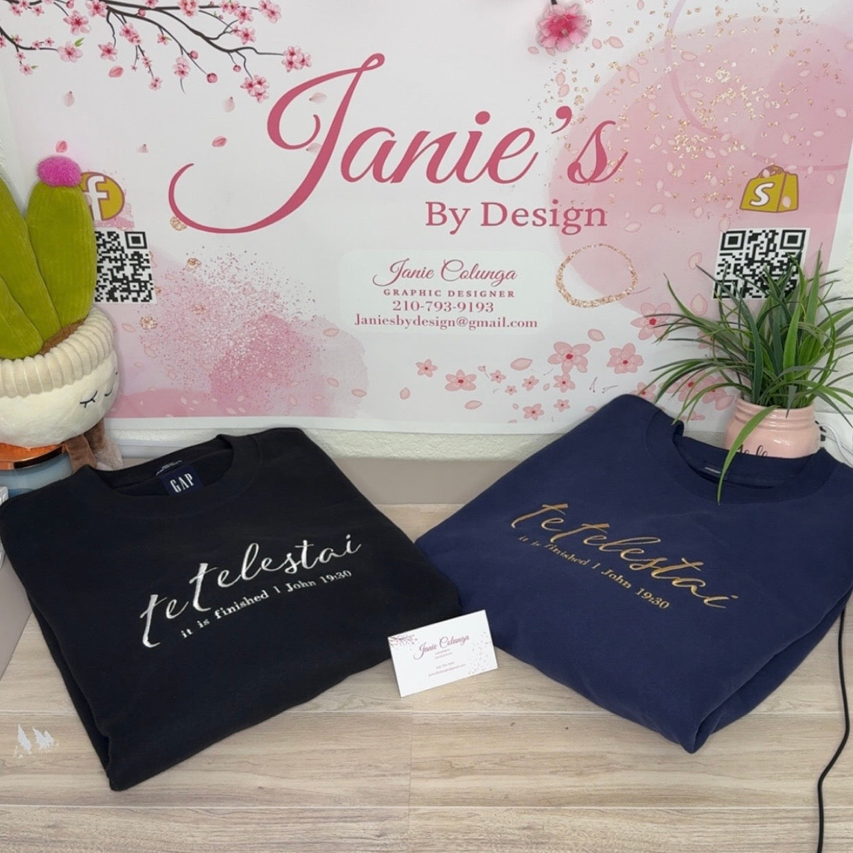 Two sweatshirts with 'telestial' text on a wooden surface with a decorative background.