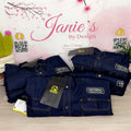 Stack of blue denim jackets with Universal Repair & Sales tags on a light pink background with cherry blossoms.