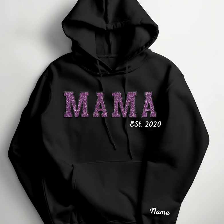 Black hoodie with 'MAMA' written in bold letters, followed by 'ESTL 2020' and a placeholder for a name on the lower left side.