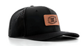 Black cap with a leather patch on a white background